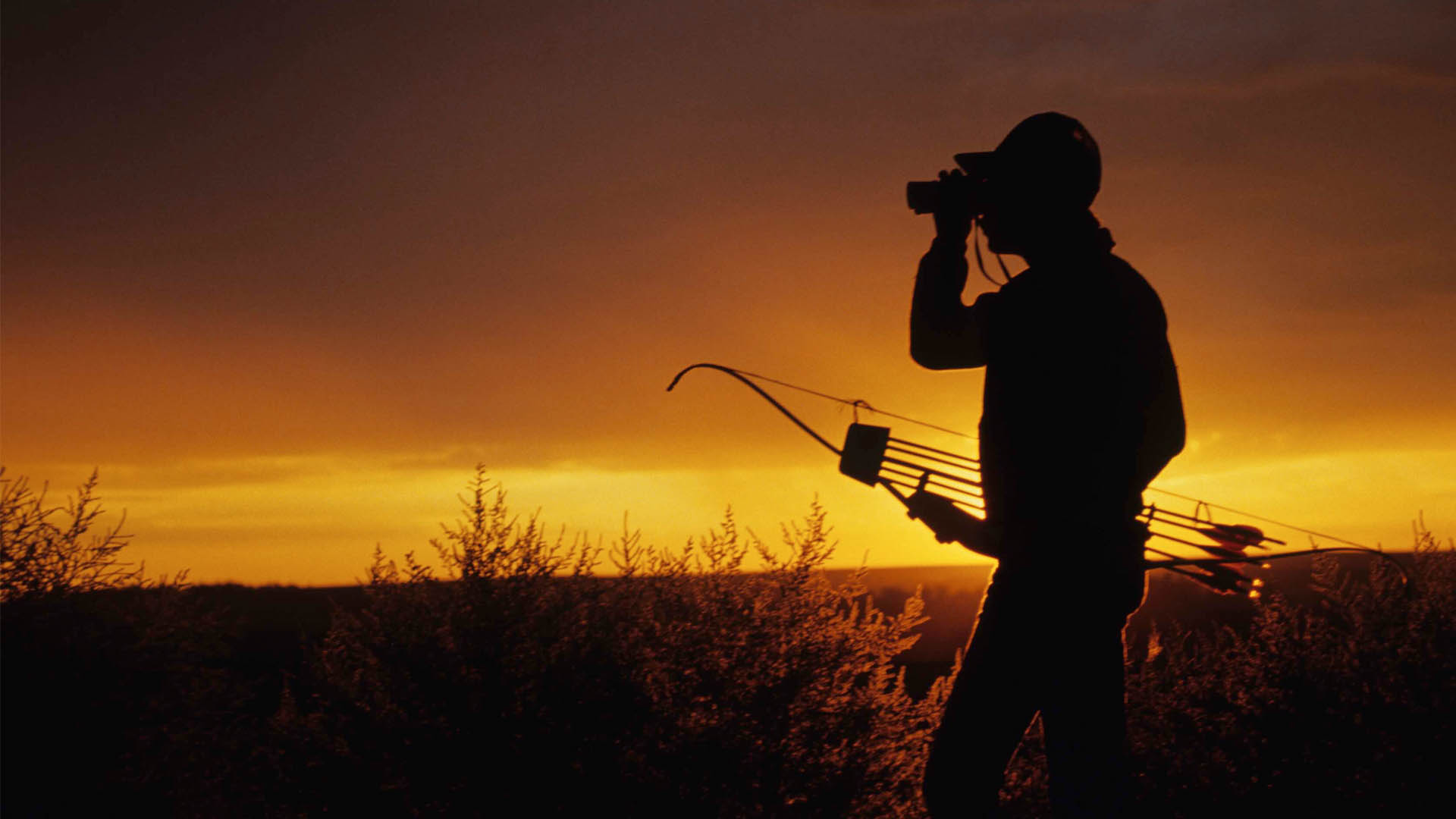 Ohio bow hunter with binoculars and bow